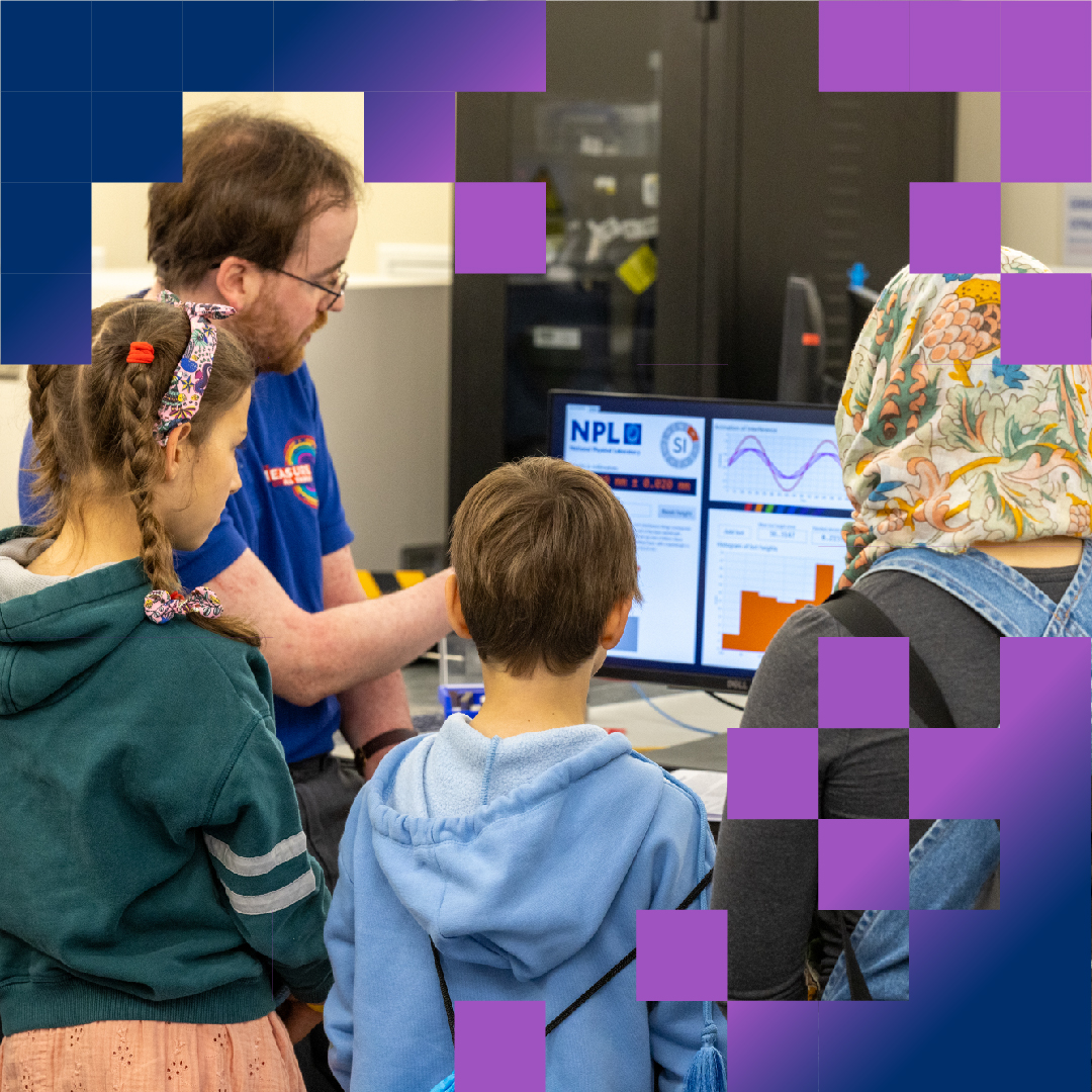 Visitors looking at monitor with NPL employee