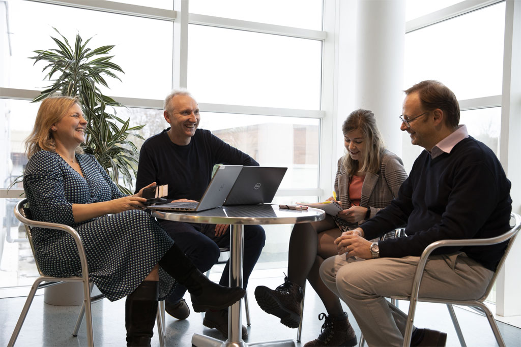 Collegues sitting around a table collaborating